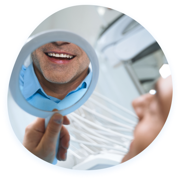 Man smiles in mirror, showing teeth.